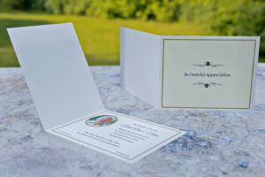 Folding acknowledgement card with cream background and floral pattern on the front