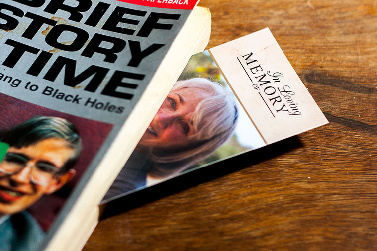 Bookmark sticking out of a book, placed on a wooden table