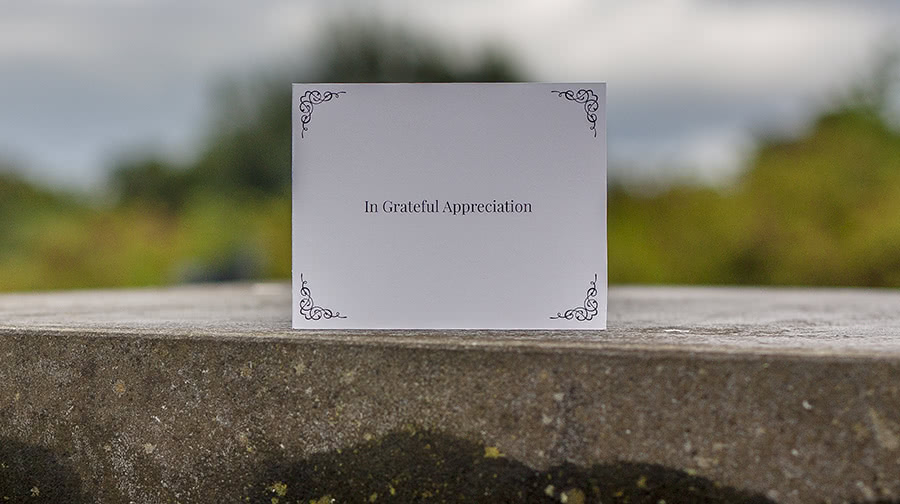 AC3 acknowledgement card, placed on a concrete pillar, outdoors, shallow DOF.