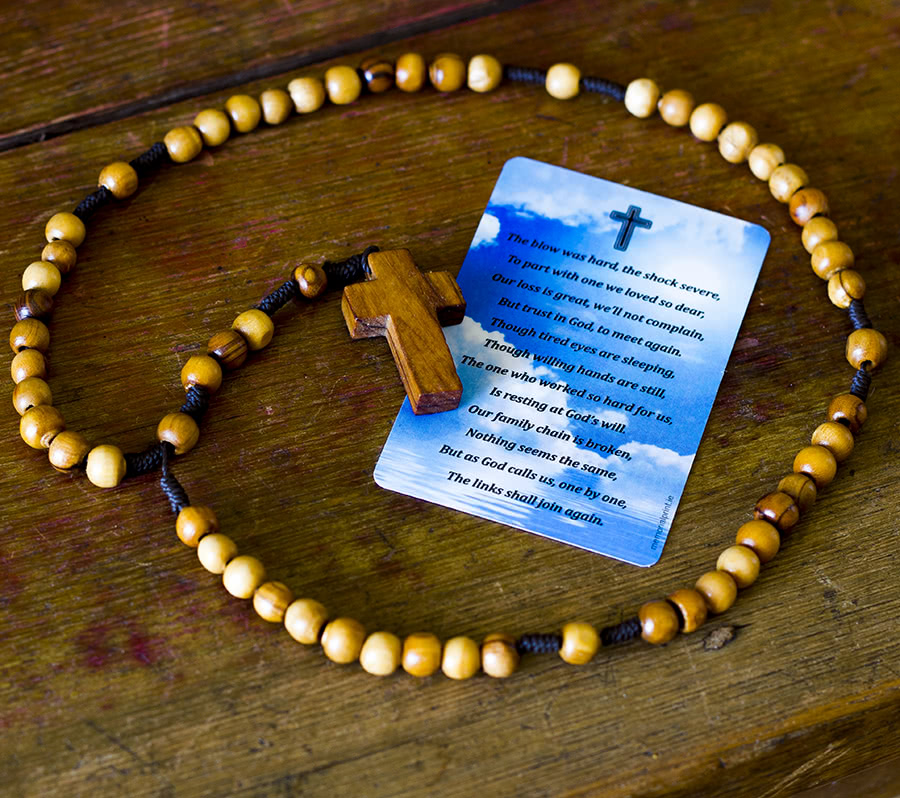 Rosary around wallet card with a poem