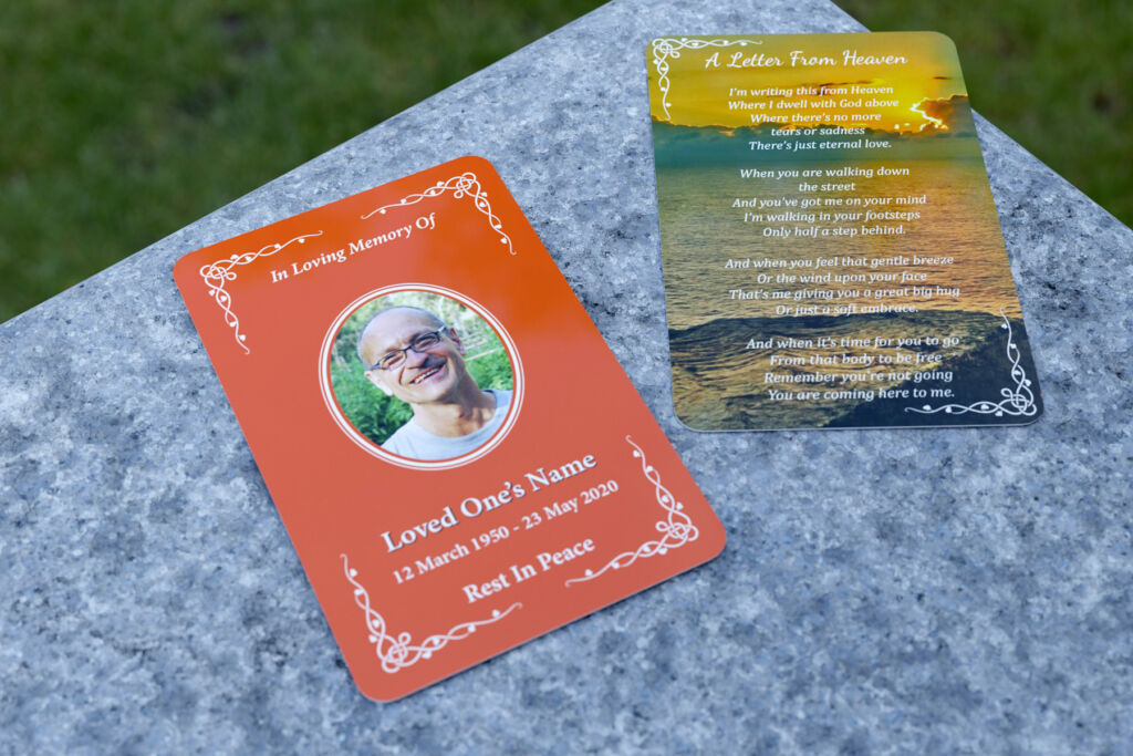 Front and back of a wallet memorial card, placed on a stone surface, outdoors, 3d render.
