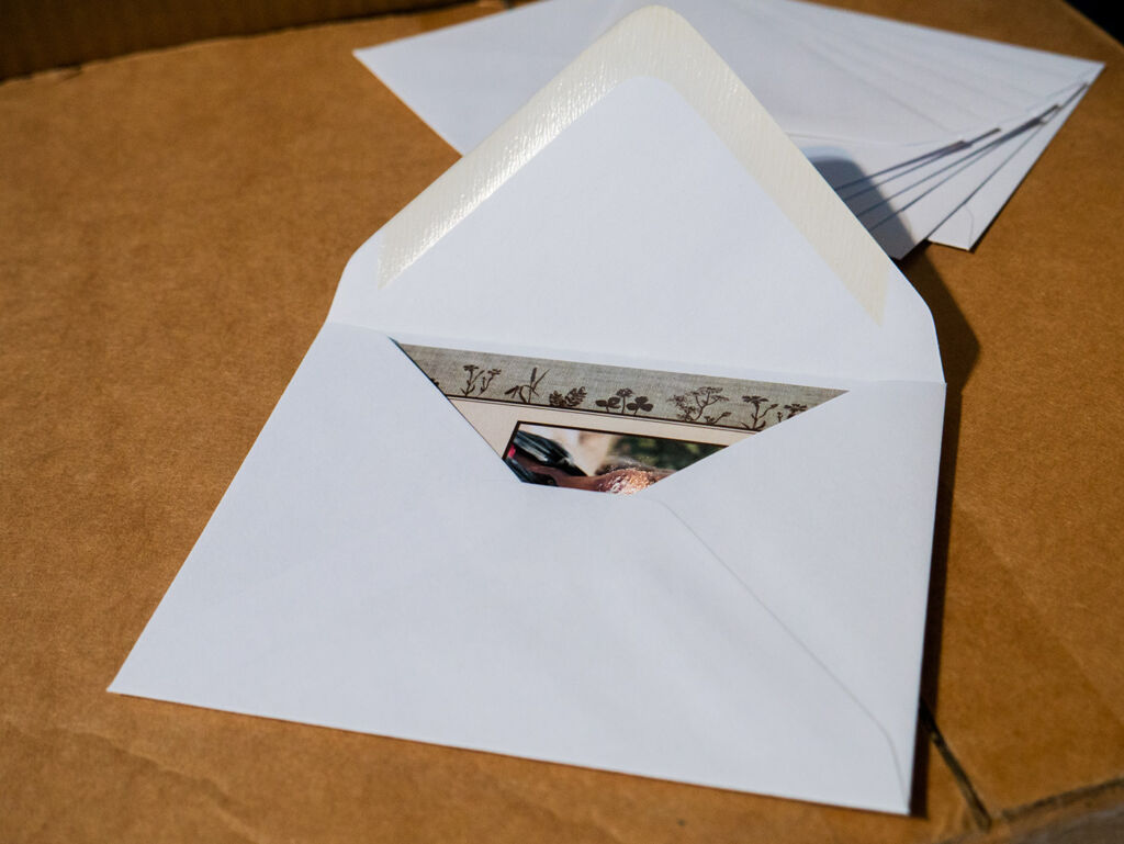 Open envelope with memorial card inside, showing how the card fits.