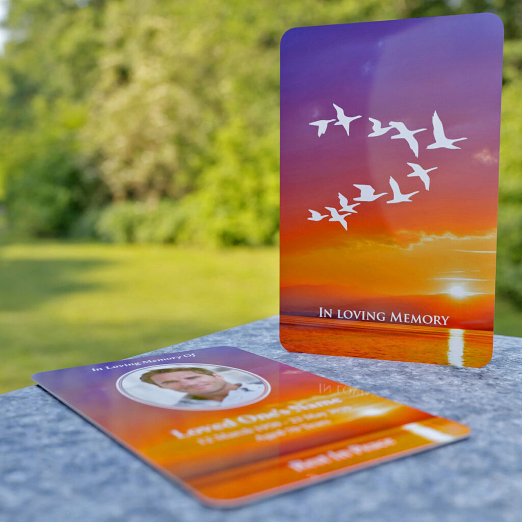 Wallet Memorial Card with image of departing birds and scenic background.