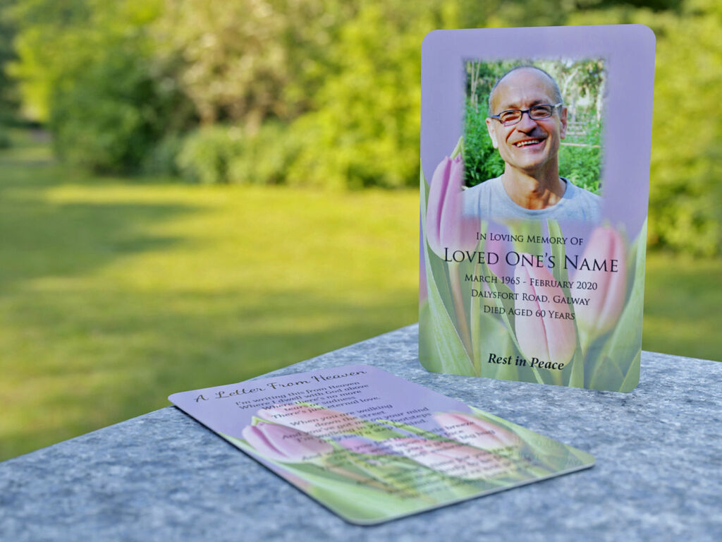 wallet memorial card with feathered photo and flowers in background